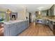 Open kitchen features stainless appliances, gray cabinets, and a large island at 207 Crossing Ave, Belmont, NC 28012