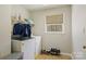 Functional laundry room with a washer, dryer, and a small window at 207 Crossing Ave, Belmont, NC 28012