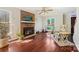 Comfortable living space showcasing a brick fireplace, hardwood floors, and a cozy chair near a window at 207 Crossing Ave, Belmont, NC 28012