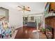 Spacious living room featuring a brick fireplace, hardwood floors, and an open layout connecting to the kitchen at 207 Crossing Ave, Belmont, NC 28012