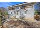Exterior view of a shed with a gravel entryway, an American flag, and siding at 207 Crossing Ave, Belmont, NC 28012