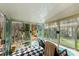 Sunroom featuring checkered floors, many windows with views, and comfortable seating at 207 Crossing Ave, Belmont, NC 28012