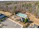 Aerial view of the community pool, clubhouse, playground, and parking lot surrounded by lush trees at 3181 Helmsley Ct, Concord, NC 28027