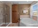 Bathroom features a large soaking tub, separate shower, and ample cabinet space for storage and convenience at 3181 Helmsley Ct, Concord, NC 28027