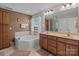 Bathroom featuring a soaking tub, double vanity, and a separate shower, providing a spa-like experience at 3181 Helmsley Ct, Concord, NC 28027