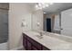 Full bath with a large vanity, updated lighting and white wall paint at 3181 Helmsley Ct, Concord, NC 28027