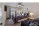 Bedroom featuring an updated ceiling fan, windows and a comfortable upholstered chair at 3181 Helmsley Ct, Concord, NC 28027