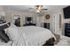 Spacious bedroom with a ceiling fan, connected bathroom, closet, and ample natural light at 3181 Helmsley Ct, Concord, NC 28027