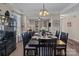 Elegant dining area with dark wood table set and open access to living room at 3181 Helmsley Ct, Concord, NC 28027