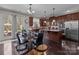 Well-lit kitchen with stainless appliances, granite countertops, central island and adjacent dining area at 3181 Helmsley Ct, Concord, NC 28027