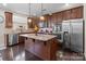 Spacious kitchen with stainless steel appliances, granite countertops, and dark wood cabinets at 3181 Helmsley Ct, Concord, NC 28027
