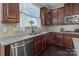 Well-lit kitchen showcasing stainless steel appliances and granite countertops at 3181 Helmsley Ct, Concord, NC 28027