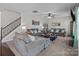 Spacious living room with neutral walls, plush seating, staircase, and ceiling fan at 3181 Helmsley Ct, Concord, NC 28027