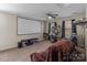 Entertainment space with projector screen, comfortable seating and desk area at 3181 Helmsley Ct, Concord, NC 28027
