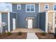 A shot of the backyard patio with a small yard and two entrances to neighbors in a townhouse-style setting at 336 A Lincoln St, Concord, NC 28025