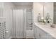 Bathroom with shower-tub, white cabinets, quartz countertops and decorated with a flower vase and stylish towel at 336 A Lincoln St, Concord, NC 28025