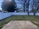 View of backyard featuring a white fence, small yard and cracked concrete at 3701 Teaberry Ct, Charlotte, NC 28227