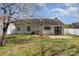 Wide view of the backyard showing the house, patio, and fence at 3701 Teaberry Ct, Charlotte, NC 28227