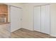 Cozy bedroom featuring laminate flooring and a closet with double doors for storage at 3701 Teaberry Ct, Charlotte, NC 28227