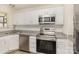 Bright kitchen with white cabinets, stainless steel appliances, and granite countertops at 3701 Teaberry Ct, Charlotte, NC 28227