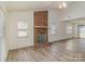 Bright living room showcasing a brick fireplace, high ceilings, and new flooring at 3701 Teaberry Ct, Charlotte, NC 28227