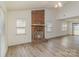 Bright living room showcasing a brick fireplace, high ceilings, and new flooring at 3701 Teaberry Ct, Charlotte, NC 28227