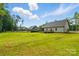 Expansive backyard with lush green grass and a deck, perfect for outdoor entertaining and relaxation at 409 Henry Chapel Rd, Belmont, NC 28012