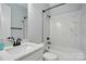 Bright bathroom with modern fixtures, featuring a stylish vanity and a shower-tub combination with marble-style tile surround at 409 Henry Chapel Rd, Belmont, NC 28012