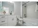 Clean bathroom with a white vanity, tiled floor, and a shower-tub combination with sleek, modern fixtures at 409 Henry Chapel Rd, Belmont, NC 28012