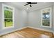 Bedroom with hardwood floors, two windows, and a ceiling fan at 409 Henry Chapel Rd, Belmont, NC 28012