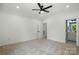 Spacious bedroom featuring neutral carpet, a ceiling fan, and an ensuite bathroom for added convenience and privacy at 409 Henry Chapel Rd, Belmont, NC 28012