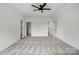 Expansive bedroom with neutral carpeting, ceiling fan, and doors to an ensuite bathroom and closets at 409 Henry Chapel Rd, Belmont, NC 28012