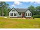 Charming single-story home with a red front door, black shutters, and a well-manicured lawn at 409 Henry Chapel Rd, Belmont, NC 28012