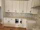 Modern kitchen with white cabinets, quartz countertops, stainless steel microwave, and stylish backsplash at 409 Henry Chapel Rd, Belmont, NC 28012