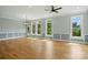 Bright and airy living room with hardwood floors, wainscoting, and large windows offering scenic views at 409 Henry Chapel Rd, Belmont, NC 28012