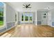 Spacious living area featuring hardwood floors, wainscoting, and abundant natural light at 409 Henry Chapel Rd, Belmont, NC 28012