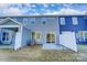Back of townhomes showing siding, sliding doors, and small concrete patios at 4211 Black Ct # 193, Harrisburg, NC 28075