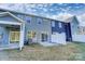 Rear view of home showcasing siding, sliding glass doors, and small patio at 4211 Black Ct # 193, Harrisburg, NC 28075