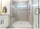 This bathroom features a tiled shower with glass door, built in bench and shower niche, and white vanity at 4211 Black Ct # 193, Harrisburg, NC 28075