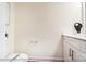 A powder room features a toilet, modern fixtures, white cabinets, and a quartz countertop at 4211 Black Ct # 193, Harrisburg, NC 28075