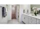 This bathroom boasts a white vanity with white countertops, mirror and access to a walk-in closet at 4211 Black Ct # 193, Harrisburg, NC 28075