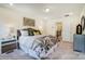 A bedroom features great natural light, comfortable carpet, and modern art above the bed at 4211 Black Ct # 193, Harrisburg, NC 28075