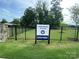 Sign for the Harrisburg Village community dog park behind a black fence at 4211 Black Ct # 193, Harrisburg, NC 28075