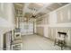 An unfinished garage features an automatic door, paint-ready drywall, and space for parking at 4211 Black Ct # 193, Harrisburg, NC 28075