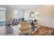 Bright, modern living room with sliding door, contemporary furniture, and hardwood floors at 4211 Black Ct # 193, Harrisburg, NC 28075