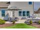 Paver patio with seating, grill, and manicured lawn, offers a perfect outdoor living space at 4219 Huntley Glen Dr, Pineville, NC 28134