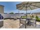 Beautiful outdoor patio with stone pavers, comfortable seating, and a large umbrella for shade at 4219 Huntley Glen Dr, Pineville, NC 28134