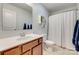 Neutral bathroom with a single vanity sink, white door and blue hand towels at 4219 Huntley Glen Dr, Pineville, NC 28134