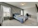 A bedroom with a unique accent wall, neutral carpet, and lots of natural light creates an inviting atmosphere at 4219 Huntley Glen Dr, Pineville, NC 28134