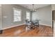 Well-lit dining area showcases hardwood floors, modern lighting, and a stylish table perfect for Gathering meals at 4219 Huntley Glen Dr, Pineville, NC 28134